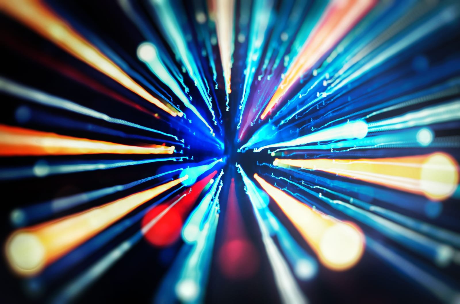 Streaks of colored light converging, representing focused delivery economics